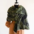 Detail of the thick mountain landscape pattern scarf with fringe on a camel coat - Green
