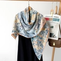Detailed close-up of luxurious herringbone silk scarf with orange hand-rolled edges - Floral Pattern Blue