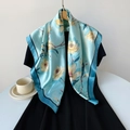 Detail of light blue satin floral square scarf with elegant magnolia print and navy border - 90x90cm / Cyan