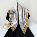 Detail of satin scarf featuring realistic white magnolia prints and golden yellow borders - 90x90cm / Yellow