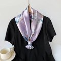 Detailed view of lavender satin floral scarf knotted elegantly over a black shirt - 90x90cm / Purple