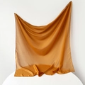 Detail of ochre silk square scarf showing soft sheen and smooth textile texture - 95x95cm / Turmeric