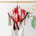 Elegant 90cm satin silk square scarf with red abstract print tied on a white dress collar - Red