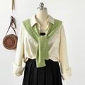 Detail of green waffle knit shawl worn over a white shirt with a black pleated skirt - 102*46cm / Green