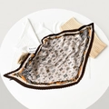 Detailed view of pleated satin square scarf featuring orange and brown feather prints - 70cm / Four-Leaf Clover