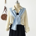 Detail of light blue cable knit shawl layered over yellow shirt and pleated black skirt - 102*46cm / Light Blue