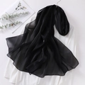 Close-up of translucent black organza hijab showing smooth silk texture and drape - Black