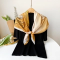 Detail of elegant yellow and white floral silk scarf tied gracefully on a black top - Yellow