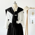 Solid black knitted cross wrap shawl for women over a white long sleeve shirt - Black