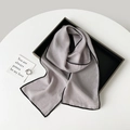 Elegant skinny light purple silk scarf with black contrast edges displayed on tray - 155*17cm / Gray