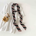 Detailed close-up of a striped narrow twilly scarf tied on a white t-shirt collar - Black Striped (P9002-Black Striped)