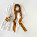 Polka dot skinny silk scarf in caramel brown draped over a white minimalist t-shirt - Dark Brown Polka Dot (P9002-Dark Brown)