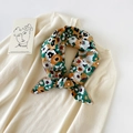 Detail of floral silk scarf with hollow lace trim tied on a beige knitted sweater neck - 70cmx70cm / Secret Garden Blue