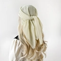 Elegant light beige chiffon headscarf for women draped over long wavy hair in a back view - 90x90cm / Cream