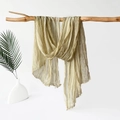 Detail of olive green crinkled jersey scarf draped over a wooden branch - 180x70cm / Yellow