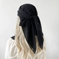 Detail view of a black chiffon headscarf showing the soft texture and lightweight fabric tie - Black