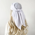 Rear view of white chiffon square headscarf tied on long blonde curly hair - White