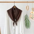 Detailed view of dark coffee pleated chiffon scarf displayed on a wooden hanger with white shirt - Dark Brown