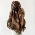 Brown vintage paisley print headscarf tied on a model with warm autumn aesthetic - 90x90cm / Brown