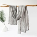 Grey crinkle textured scarf made of lightweight sheer fabric hanging on wooden branch - 180x70cm / Gray