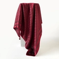Detailed view of dark red satin silk scarf with geometric jacquard pattern and elegant drape - Red