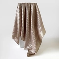 Macro view of silky champagne satin scarf with elegant geometric Greek Key jacquard pattern - Khaki