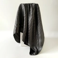 Detail showing high-gloss black satin scarf with elegant geometric Greca patterns - Black