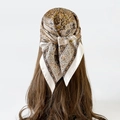 Close-up of a vintage paisley silk scarf tied in a woman's brown hair as a headband - L7315-70x70cm / White