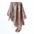 Pink striped leopard print silk scarf draped over a minimalist display stand - Pink