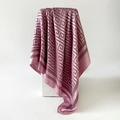 Elegant mauve silk-like scarf featuring dark Greek Key patterns on white stand - Rose Pink