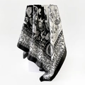 Detail of a 90cm square silk scarf featuring black and white paisley floral patterns - 90x90cm / Black (D9017)