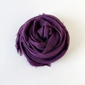 Solid deep purple cotton linen scarf with frayed edges folded into a rose shape - Violet