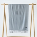 Light blue cashmere scarf with fringe details hanging on a minimalist wooden rack - Silver Grey