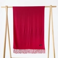 Deep red soft faux cashmere scarf with fringe tassels hanging on a wooden hanger - Wine Red