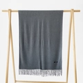 Dark grey cashmere shawl scarf with fringes hanging on a wooden hanger for winter warmth - Heather Grey