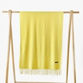 Solid bright yellow cashmere feel scarf with fine tassels hanging on a wood stand - Light Yellow
