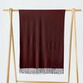 Deep wine red cashmere scarf for women with elegant tassels on a wooden hanger - Coffee