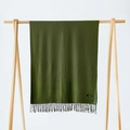 Deep green cashmere scarf with fringe tassels hanging on a minimalist wooden display stand - Army Green