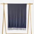Dark grey cashmere blend scarf with elegant tassels hanging on a wooden rack - Dark Gray
