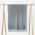 Solid grey cashmere pashmina shawl with tassel trim displayed on a wooden hanger - Light Gray