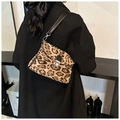 Detail of vintage leopard print crossbody bag with silver twist lock on model's shoulder - Dark Khaki