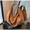 Detailed view of a brown suede large tote bag with wide shoulder strap and zipper - Yellow Brown