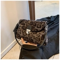 Detail showing leopard print texture and metal twist lock on a compact crossbody bag - Dark Brown