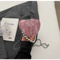 Detailed macro view of pink heart-shaped bag with silver bead handle and chain - Pink