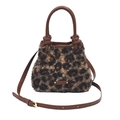 Fashionable faux fur leopard print bucket bag with brown leather handles and strap - Tan