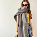 Close-up of a soft dark grey mohair shawl showing fluffy texture and premium knit detail - Gray