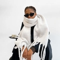 Close-up of oversized white knit mohair scarf with thick texture and long tassels - White