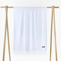 Detailed macro view of soft white cashmere scarf with fringe edges and quality logo label - Bleached White / 215*70cm