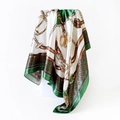 Detailed view of satin scarf with green and gold equestrian chain print on a white pedestal - 90x90cm / Green (D9035)