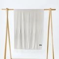 Close-up of cream cashmere scarf with fringe tassels and quality material label - Beige / 215*70cm